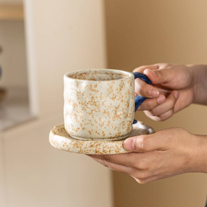 Wabi-sabi style ceramic coffee cup and saucer set